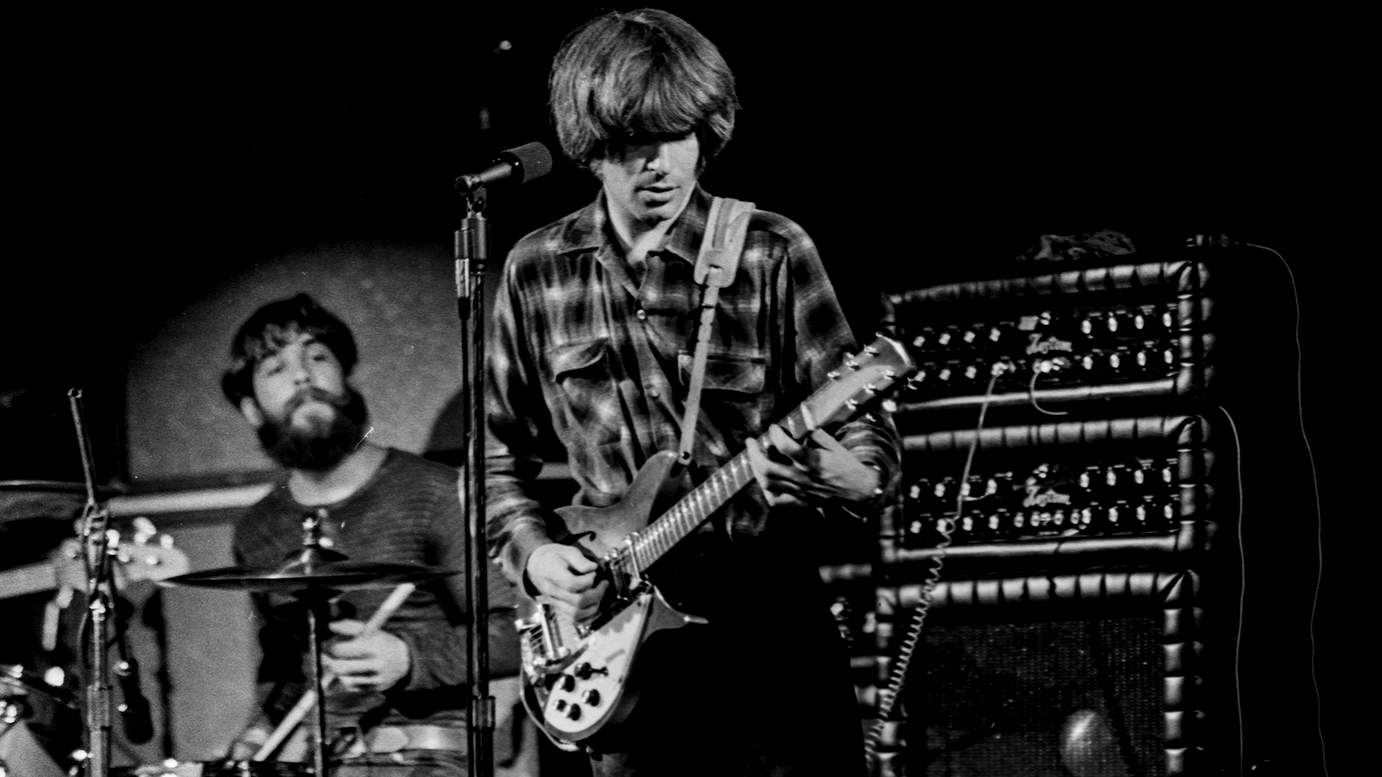 American drummer Doug Clifford and American musician, singer, and primary songwriter for Creedence Clearwater Revival play on stage at the Sam Houston Coliseum in Houston, TX on July 11, 1970.