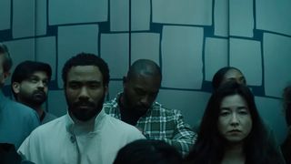 Donald Glover and Maya Erskine on an elevator in Mr. and Mrs. Smith