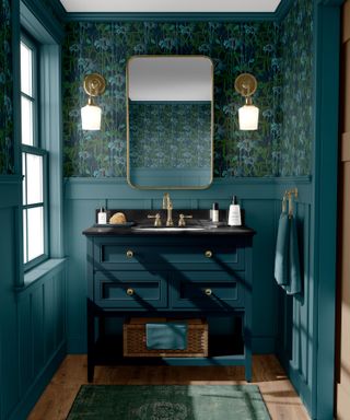 powder room is rich green with botanical wallpaper and wood paneling