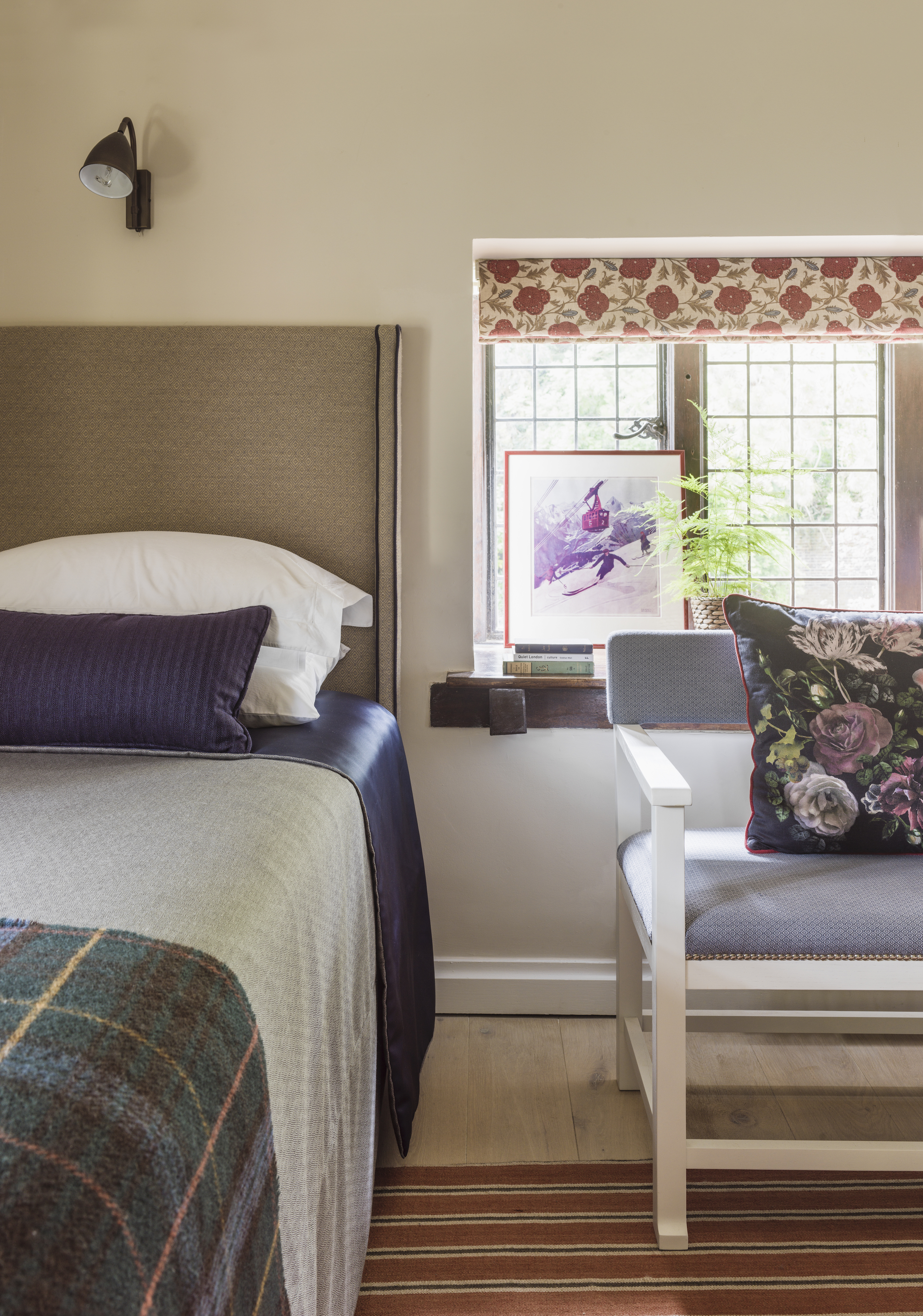 bedroom with window dressed with Roman blind and side chair