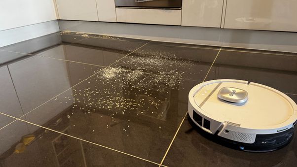 Shark PowerDetect UV Reveal on tile cleaning up debris