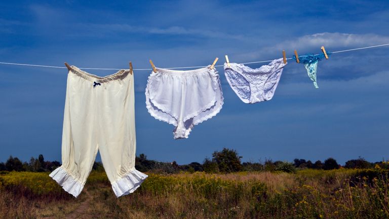 Four pairs of women's underwear from different time periods hanging on a clothes line.