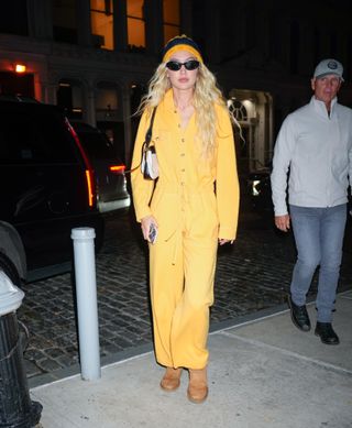 Gigi Hadid wears yellow jumpsuit and brown UGG boots
