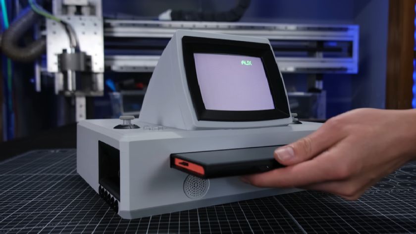 A Nintendo Switch 2 being slotted into a creator-made retro dock with CRT monitor