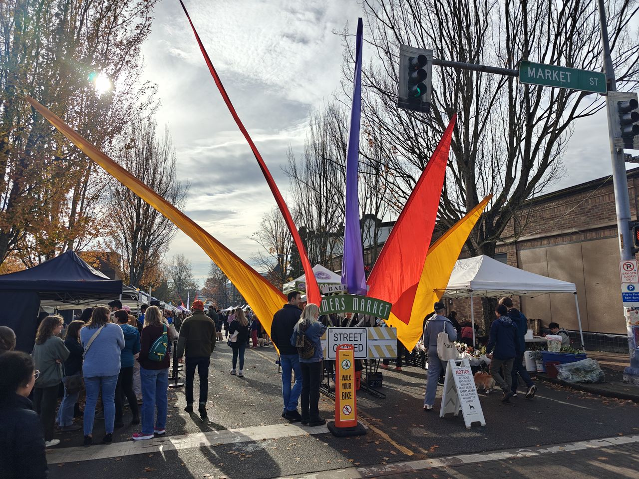Colorful flags and tends with people walking