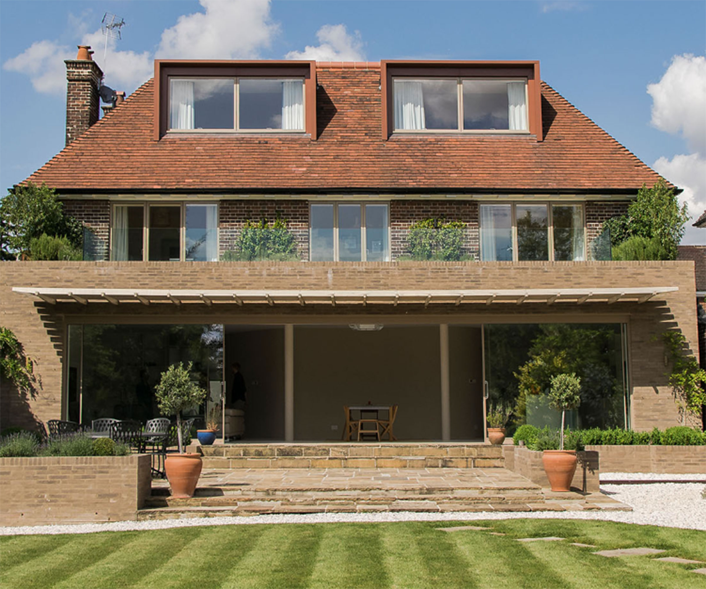 large detached house with sliding doors and brise soleil