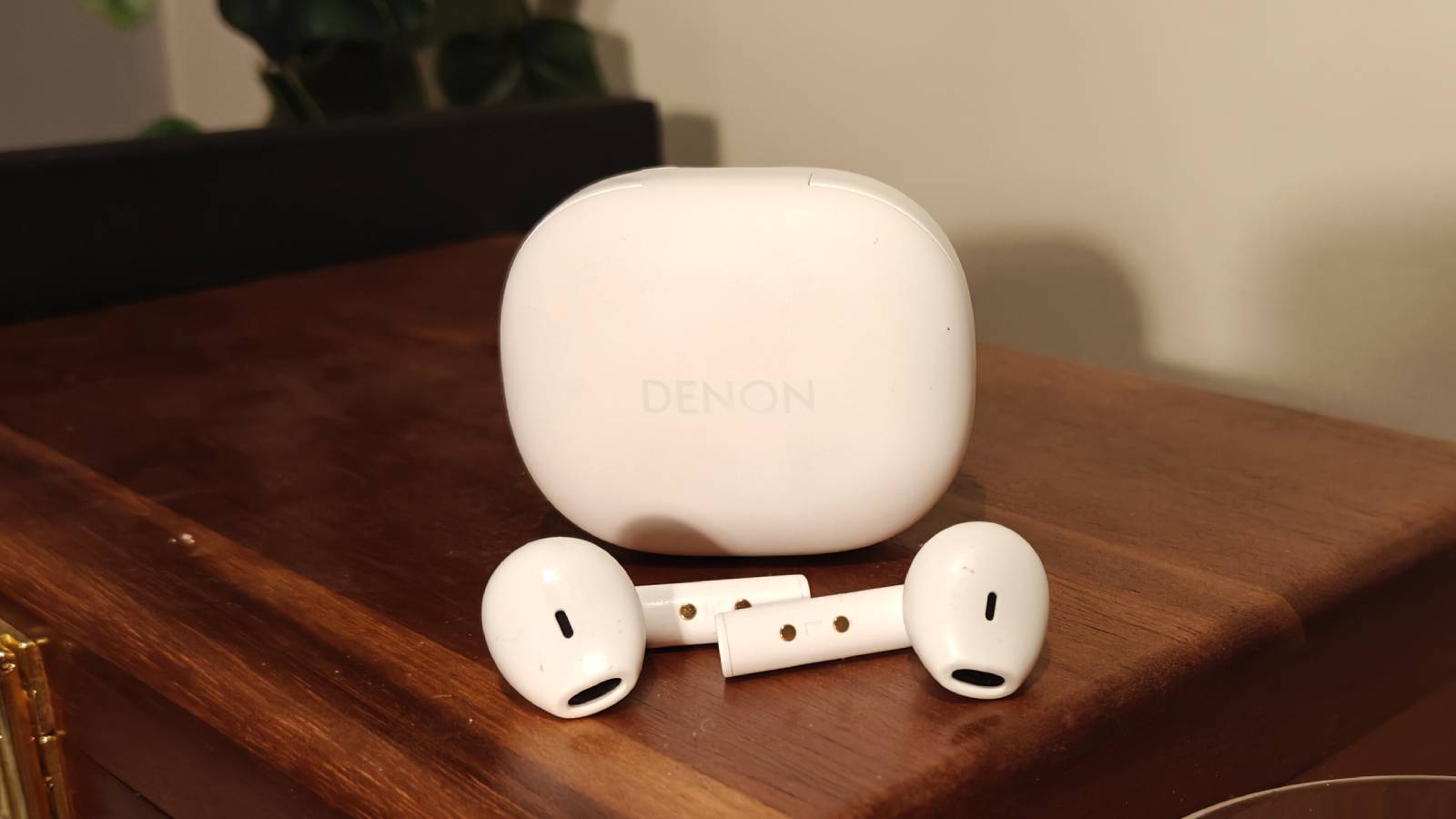 The Denon AH-C500W buds next to the case.