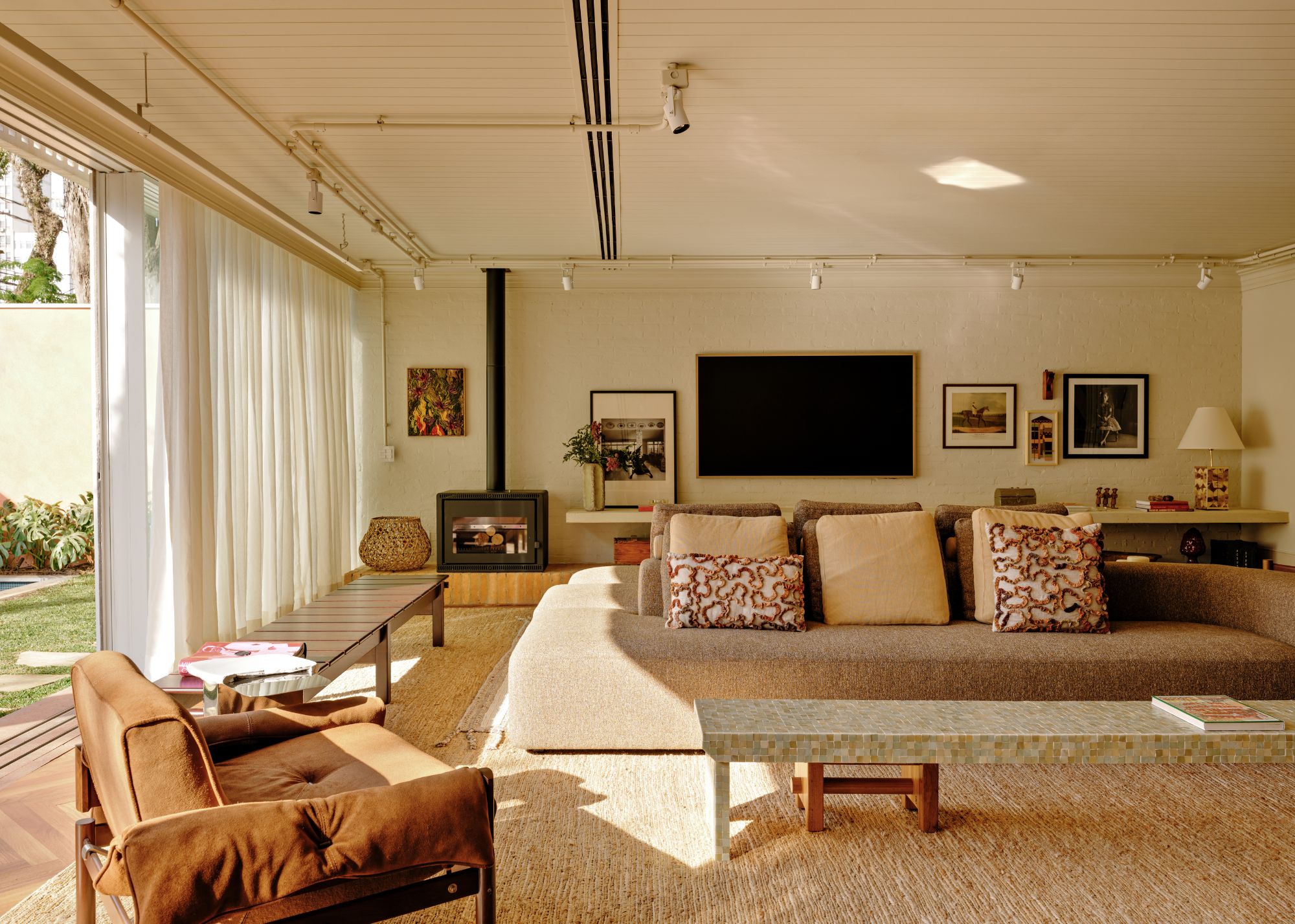 A living room with low furniture, natural fibre carpet and built-in storage