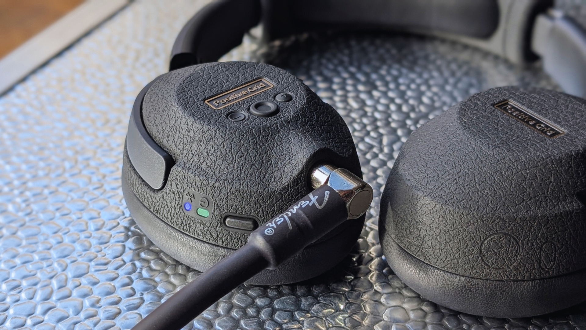 A pair of Positive Grid Spark Neo Core headphones with a Fender guitar cable plugged in