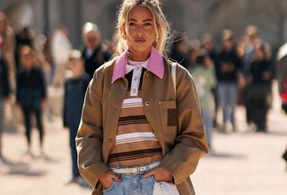 Woman in polo top and barn jacket.