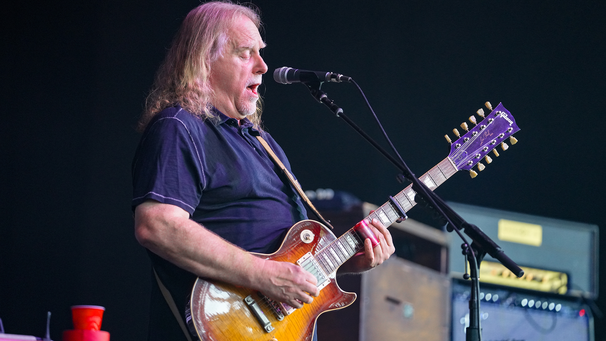 A photo of Warren Haynes performing onstage with his custom Gibson Les Paul 12-string, one of two 12-string Les Paul's the company built for him in 1990