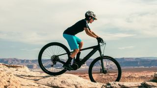 Rider on electric mountain bike in rocky landscape