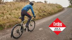 A man cycling up hill in the countryside