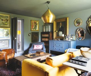 Blue living room, gold lamp, yellow sofa
