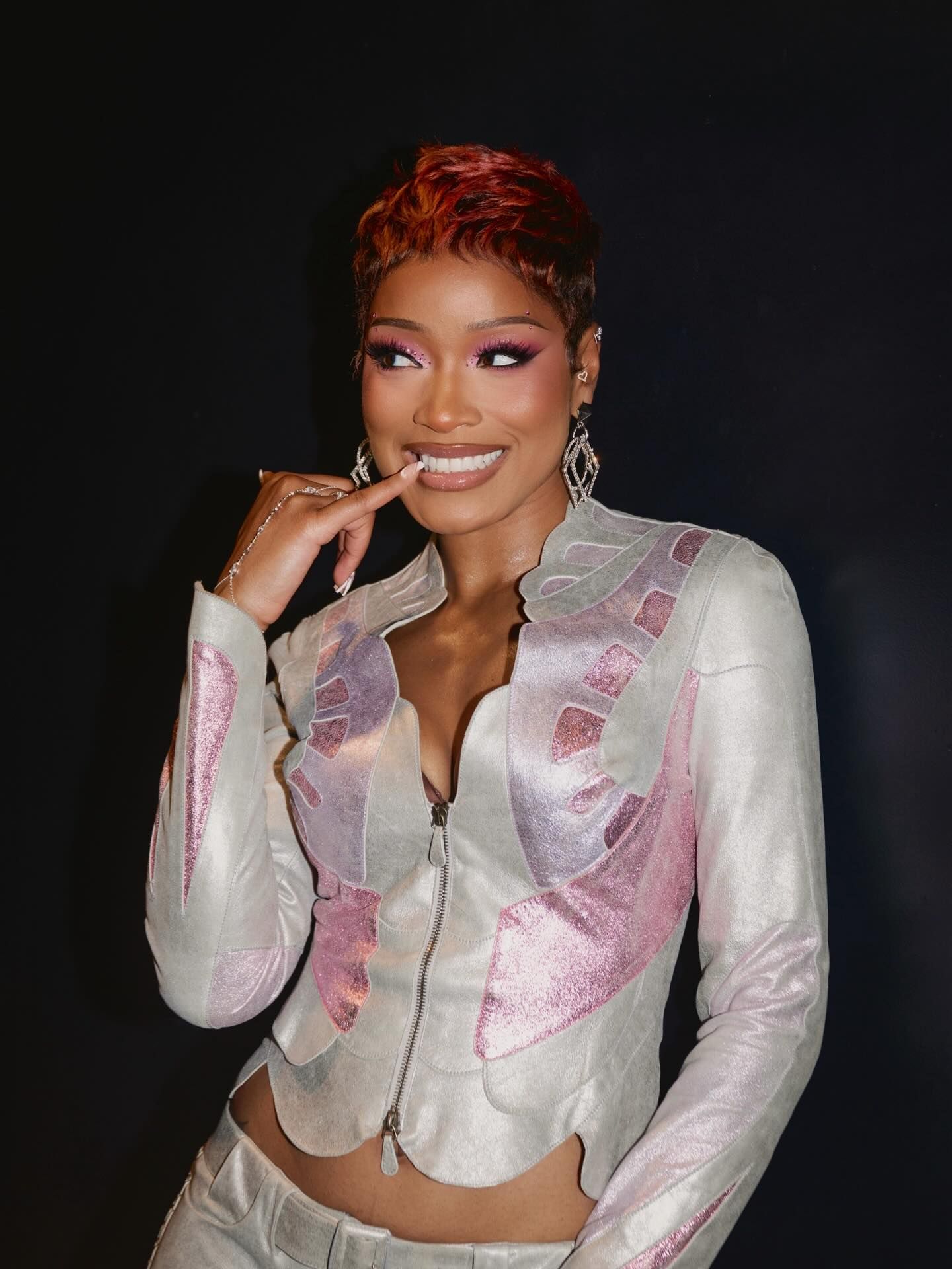 Keke Palmer with dark hair with red highlights