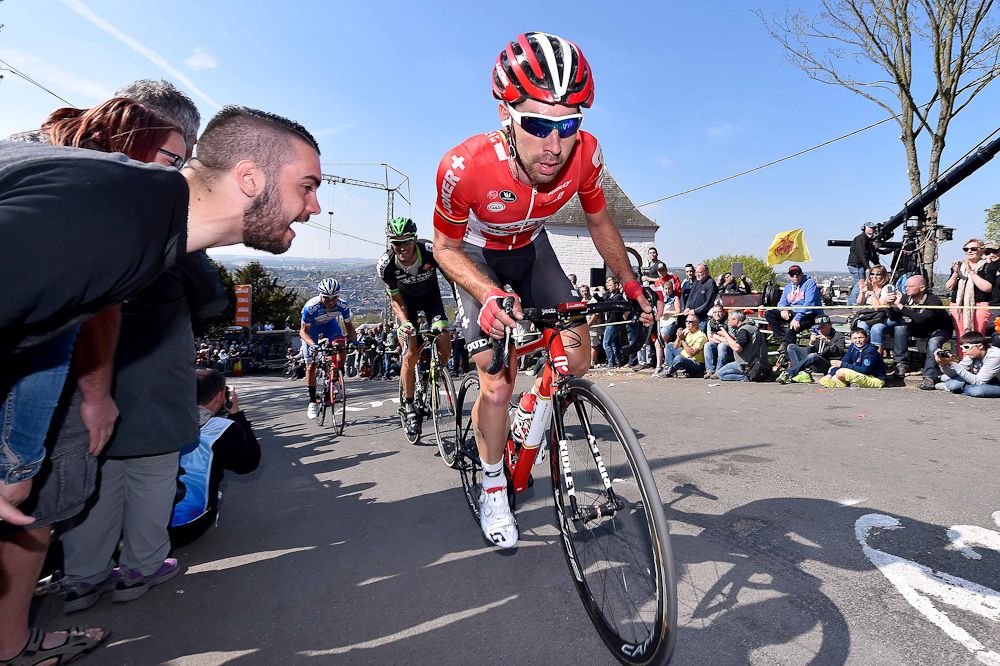 Spectators cheer on a Lotto rider.