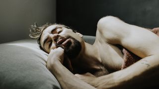 A man asleep in bed.