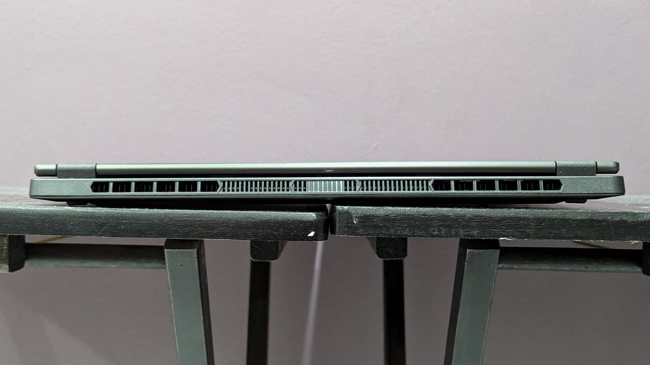 The rear thermal vents on the Asus TUF Gaming A14, sitting on a black desk.