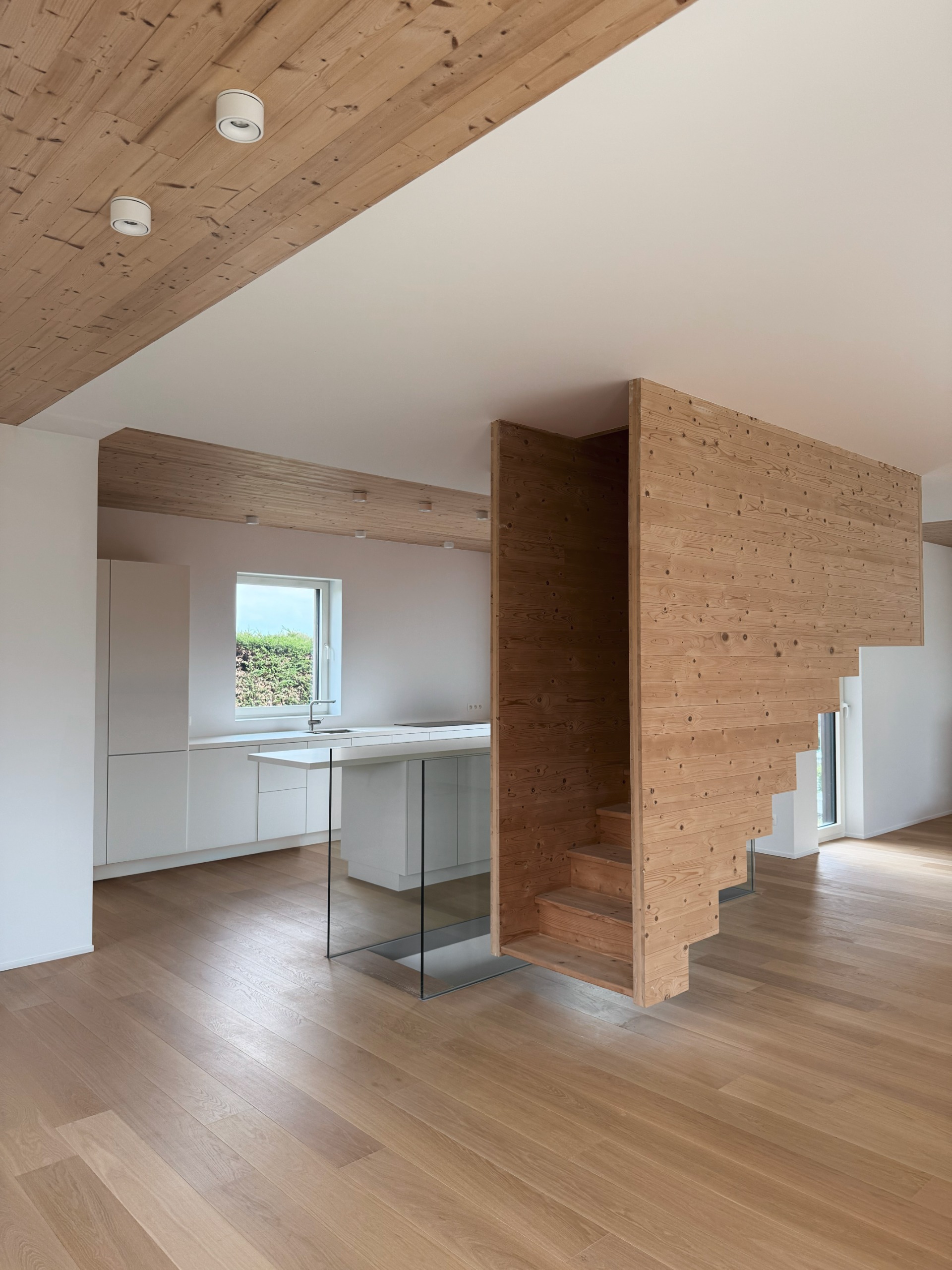 The kitchen, adjacent to the floating staircase