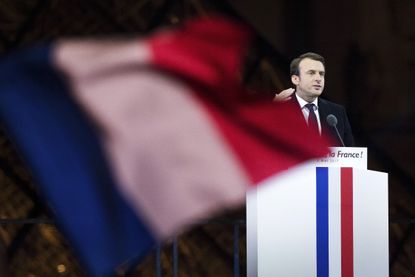 Emmanuel Macron speaks in front of The Louvre