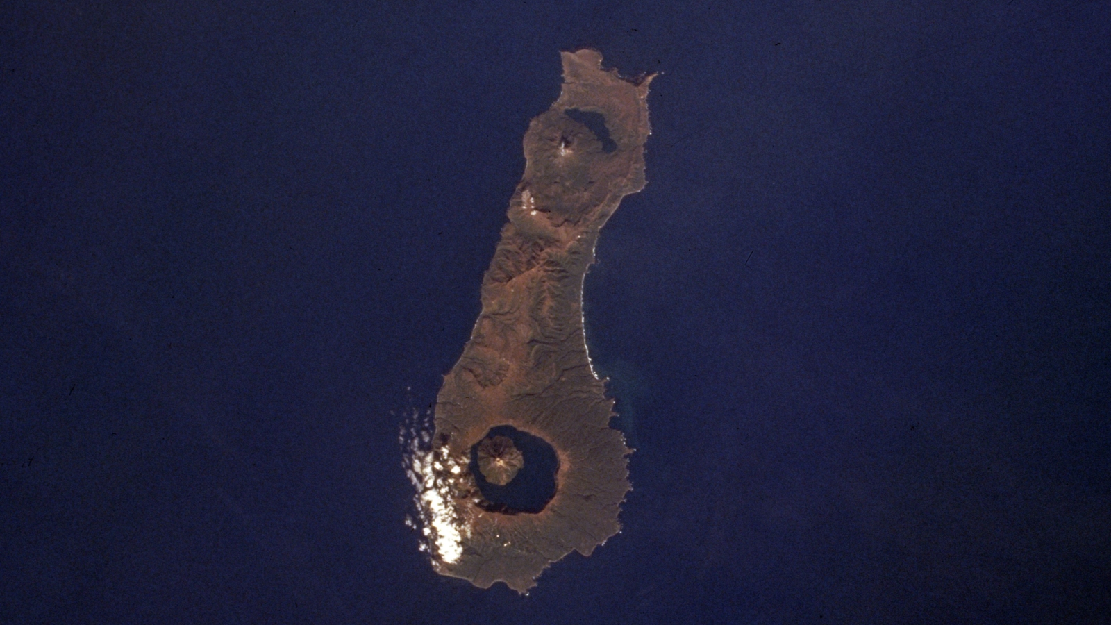 An aerial photo on Onekotan Island showing the Krenitsyna Volcano and Nemo Volcano at either ends of the land mass