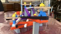 Men at Work image of a game in progress, with multicoloured beams stacked on top of one another