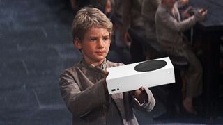 Small child holding an Xbox Series S