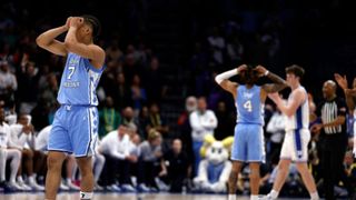 Seth Trimble holds his head in his hands during North Carolina's defeat to Duke at the ACC tournament