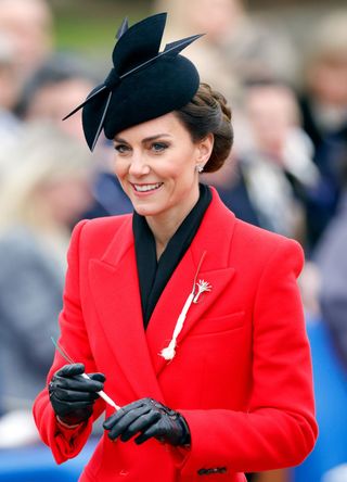 Kate Middleton in a red coat and a black hat