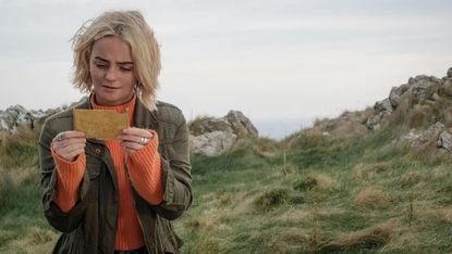 Millie Gibson's Ruby reads a note in Doctor Who season 14 episode 73 Yards