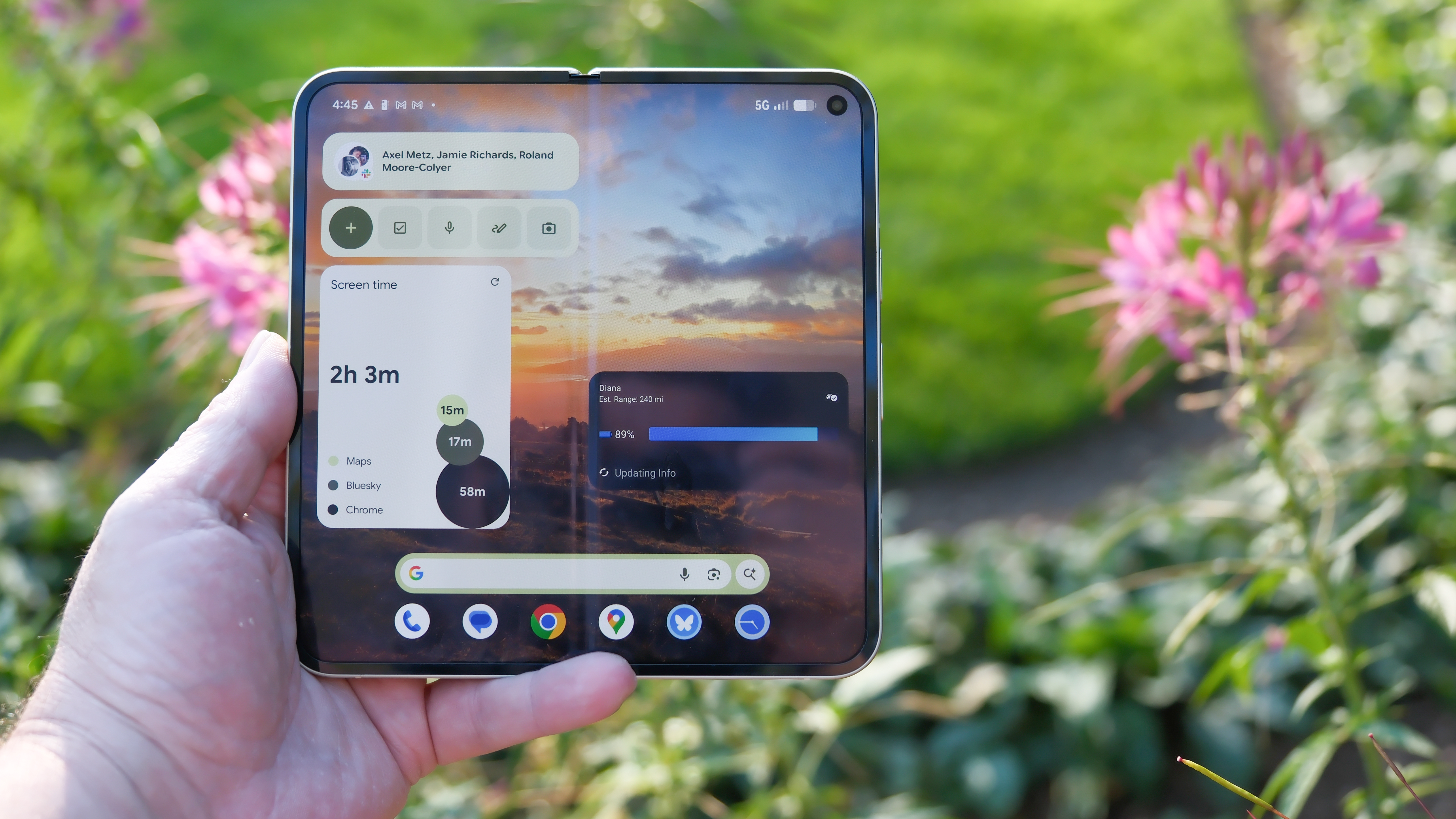 Google Pixel 10 Pro Fold in Jade green outside at a flower garden on a sunny day