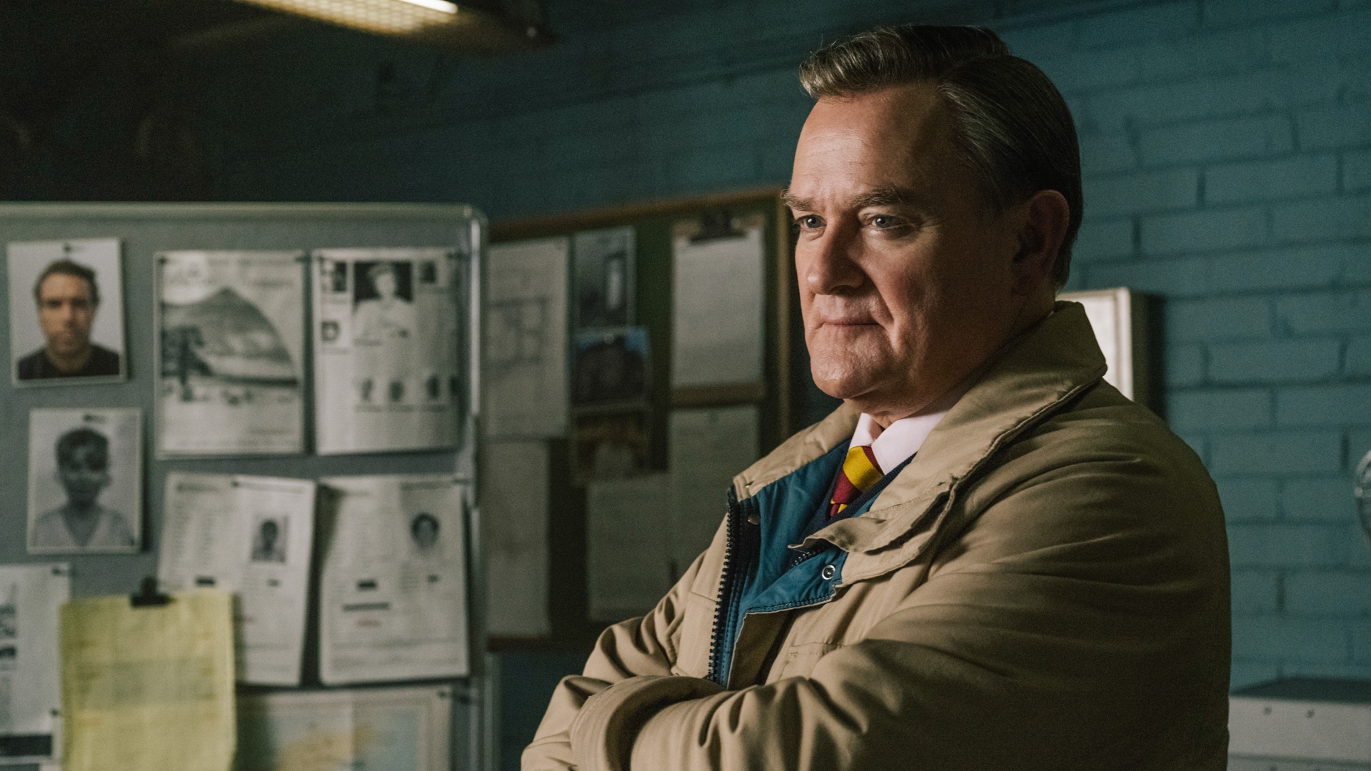 Boyce stands with his arms crossed in The Gold season 2