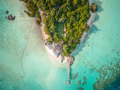 Aerial tennis court in tropical surroundings