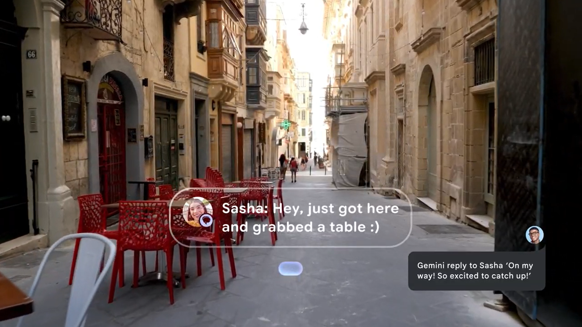 A still from an Android XR example video of how the software will look on smart glasses, showing a Google Messages pop-up from Sasha "Hey, just got here and grabbed a table" in front of a city street view, with a "Gemini reply" to the message in the corner.