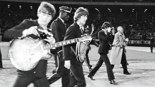 Harrison, Lennon (left) and McCartney (right) walk to the stage at Candlestick Park for the last show of their final tour, August 29, 1966.
