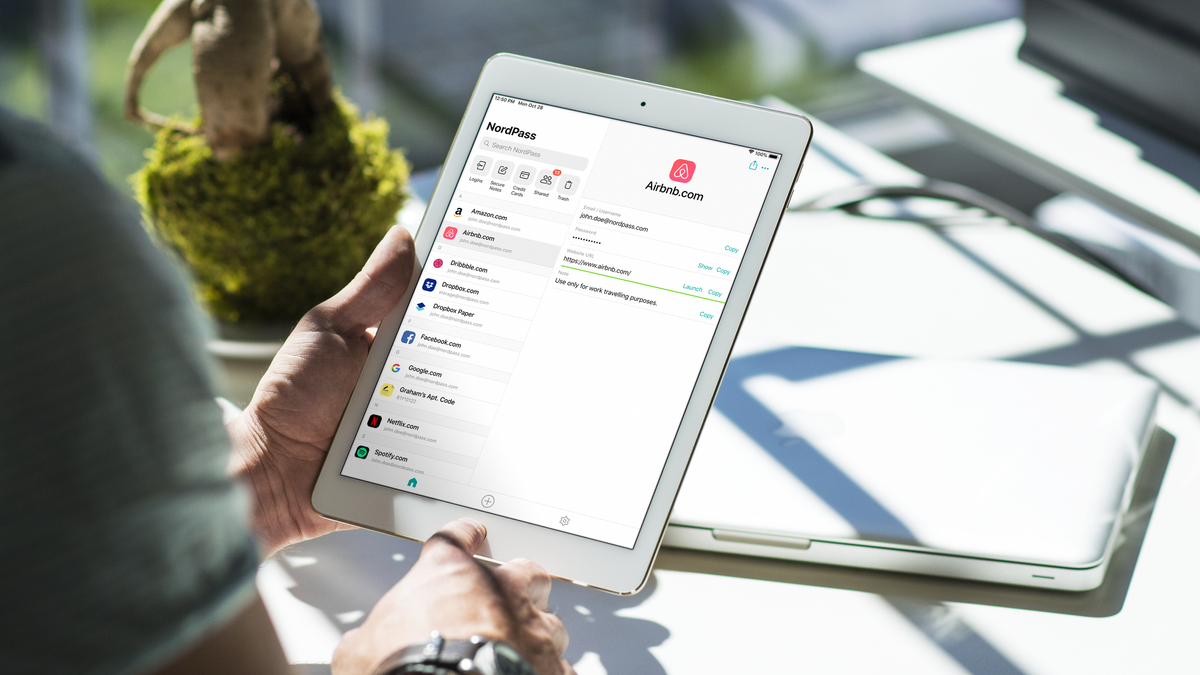 A person holding a tablet with the NordPass app displayed