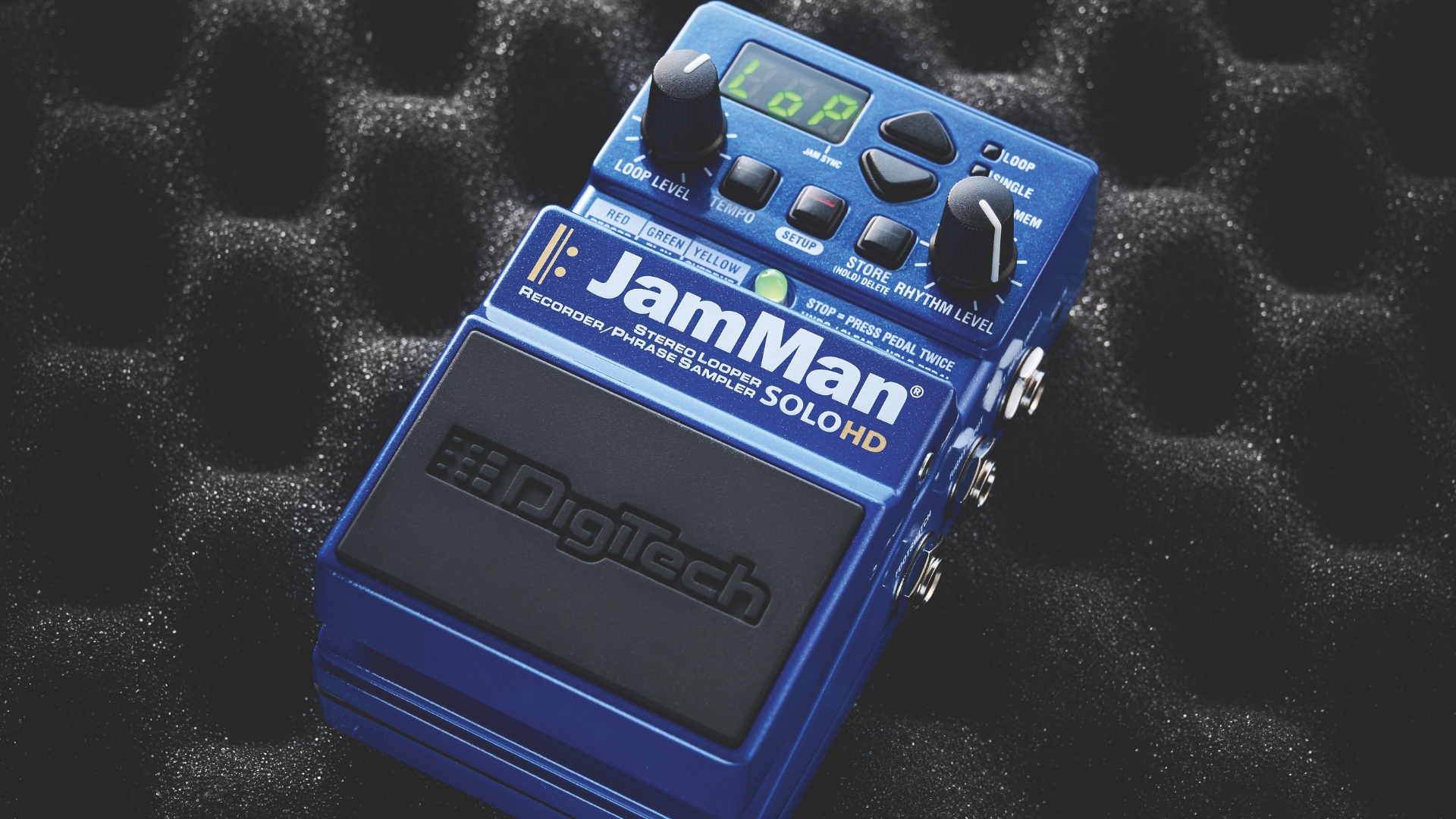 A Digitech JamMan Solo HD looper pedal lying on some acoustic foam