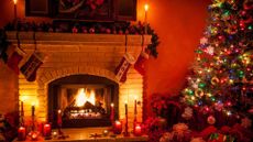 A living room with an open fire and christmas tree 