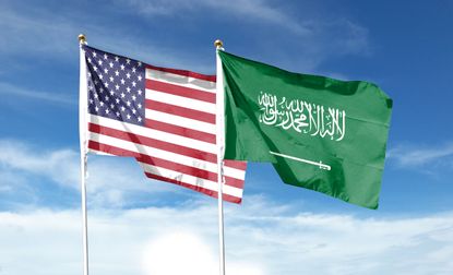American flag and Saudi Arabia flag on cloudy sky. waving in the sky