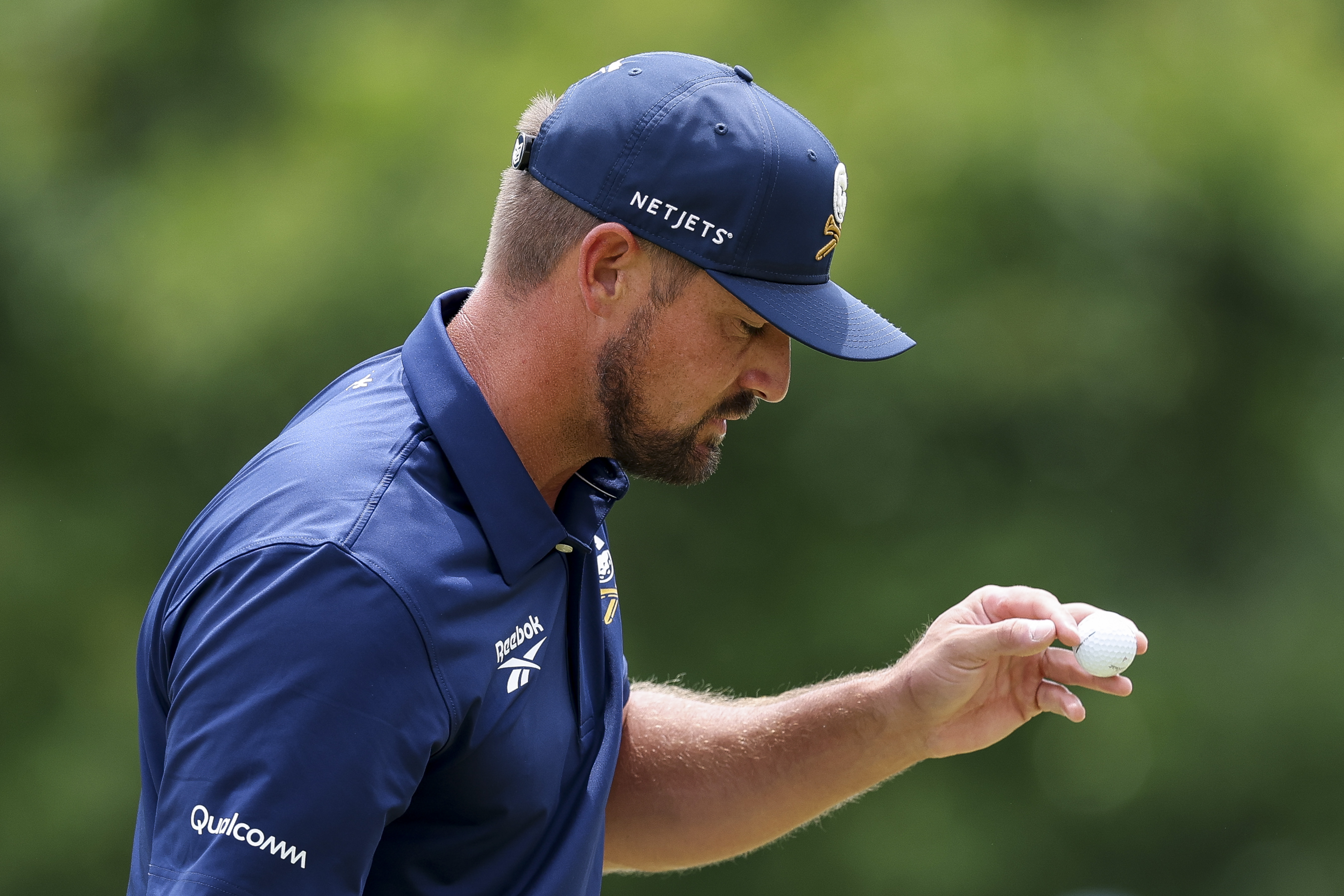 Bryson DeChambeau waves to the crowd after holing a putt