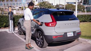 Woman plugging in XC40 to charge