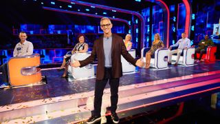 Gary Lineker poses in front of contestants for Sitting on a Fortune
