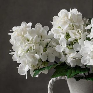 Faux white hydrangeas in a vase