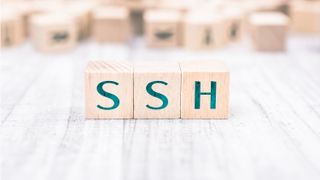 The word SSH formed by wooden blocks on a white table