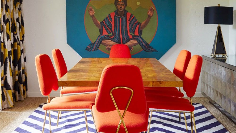 dining hall with wooden flooring and wooden table with orange chair