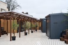 Lowlu Sauna, a Kentish town sauna, showing the outdoors area which is a timber structure with a deck, canopy and sauna cabins