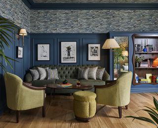 blue living room with yellow armchairs and wood panelling