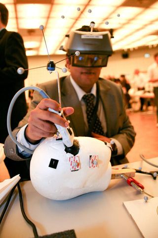 The CAMDASS headset being tried out on a plastic head during the October 2011 International Symposium on Mixed and Augmented Reality in Basel, Switzerland