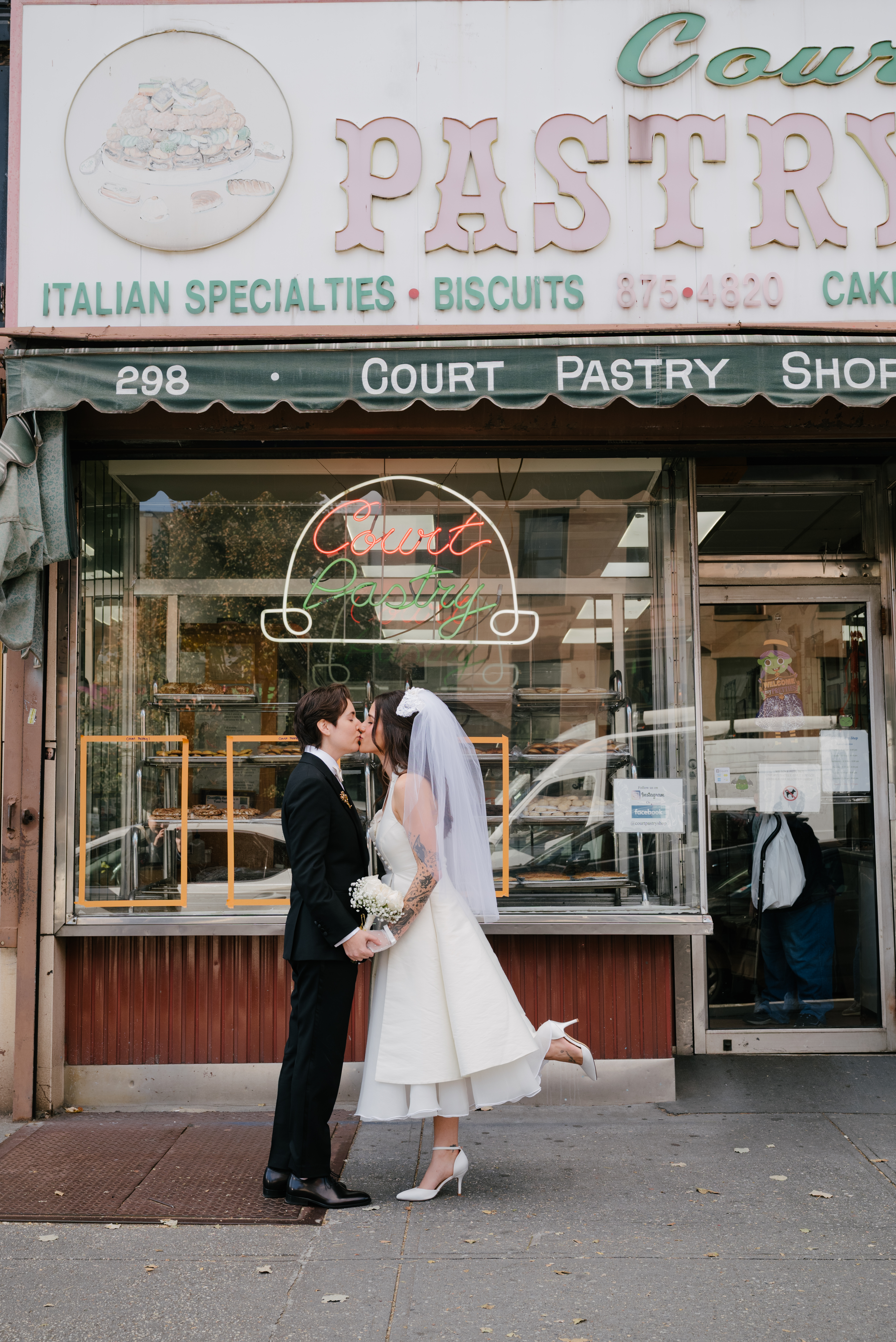 Stevie Barbieri kissing her partner wearing a vintage bridal look.