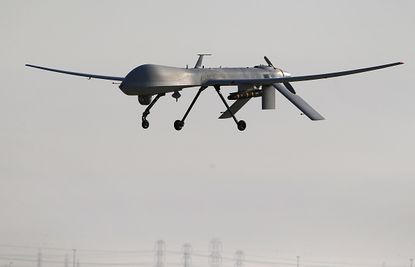 An unmanned aerial vehicle carries a Hellfire missile.